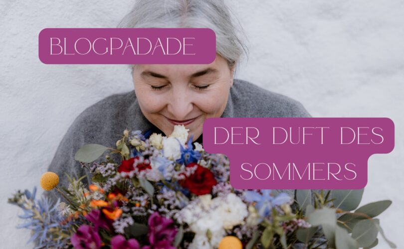Dr. Jessica Maas riecht lächelnd an einem bunten Blumenstrauß, Text „Blogparade – Der Duft des Sommers“